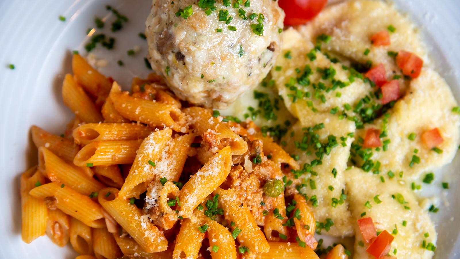 ein gemischter Teller des Gasthof Specker mit Knödel, Nudeln mit Tomatensugo und Röstkartoffeln